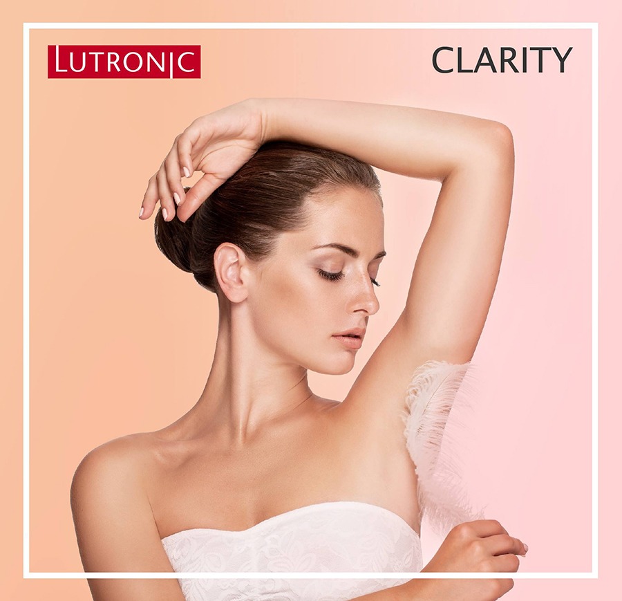 Lutronic Clarity II female model touching her smooth hairless underam with a feather