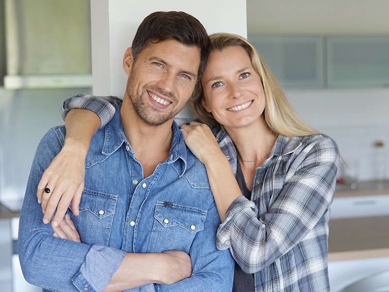 Portrait of cheerful middle-aged couple at home