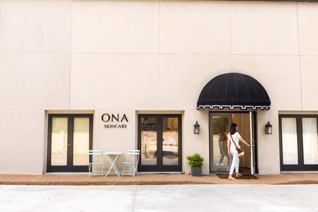 A woman entering the front door of Ona Skincare to get. a hyperpigmentation treatment in East Nashville