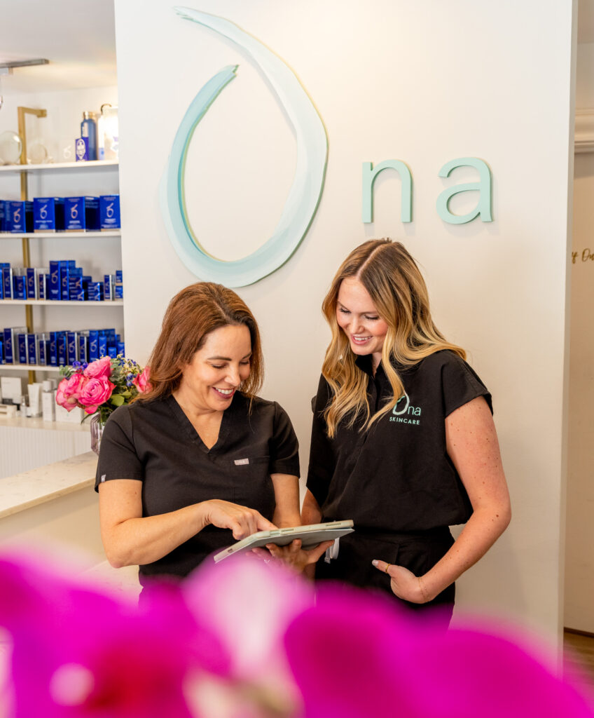 2 Ona Skincare providers discussing a patients' custom treatment plan for using our LED bed in East Nashville.