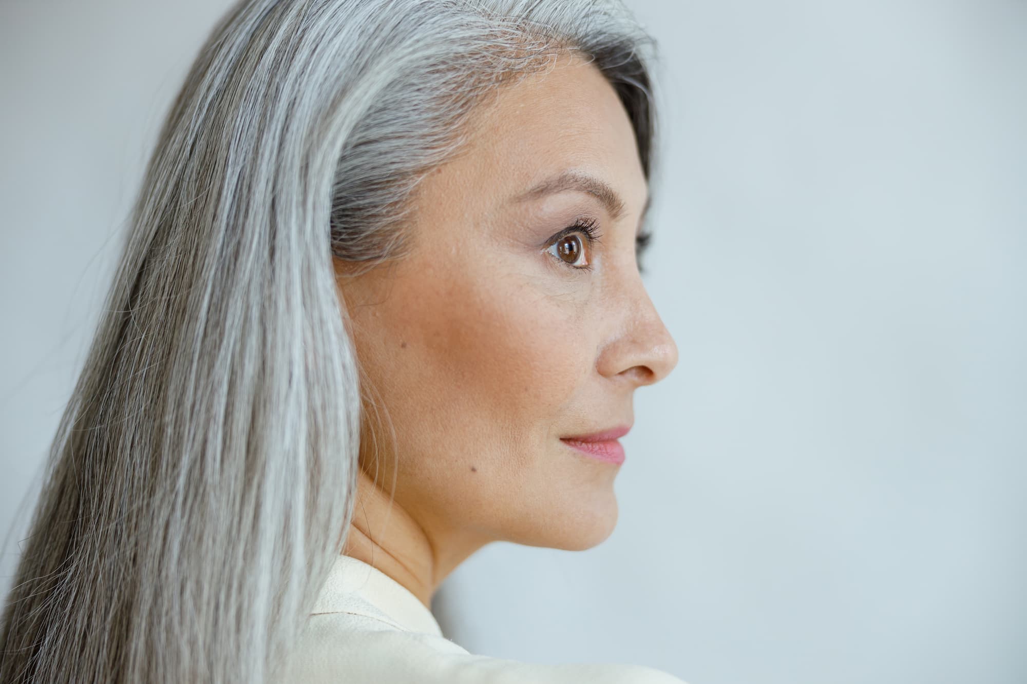 A woman in her 50s looks off-camera, contemplating seeking a provider for estrogen replacement in Franklin.