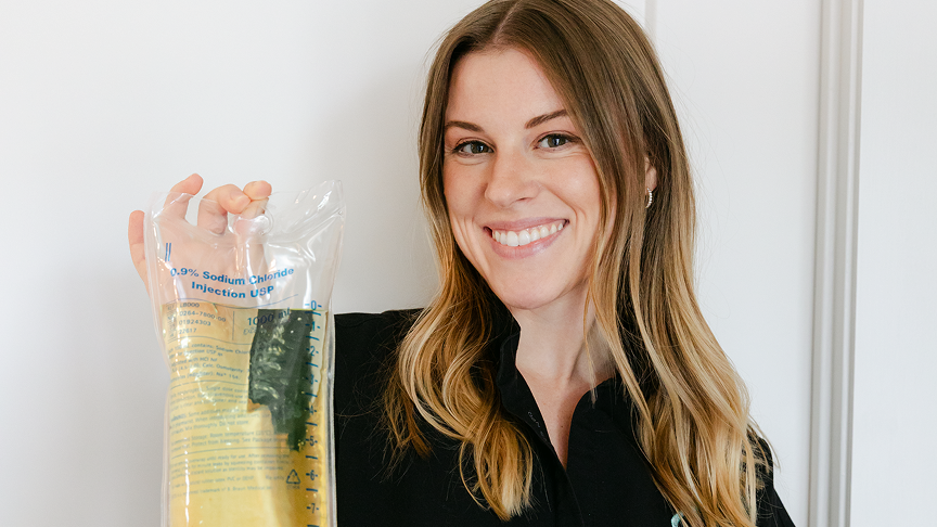 Grace, a nurse practitioner and hormone health specialist, holds a custom dose of fluids used in peptides for weight loss in East Nashville.